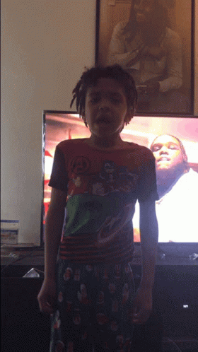 Young Boy in Superhero Shirt in Front of TV