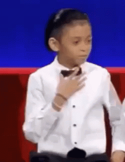 Young Boy in Tuxedo and Bow Tie Blue Background