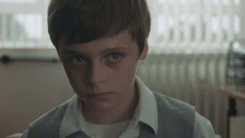 Young Boy in White Shirt and Gray Vest