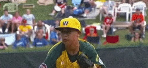 Young Boy in Yellow Hat With Letter W Playing Baseball