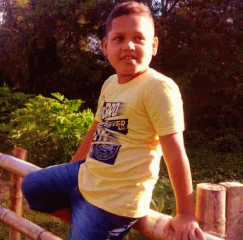 Young Boy In Yellow Superhero Shirt GIF