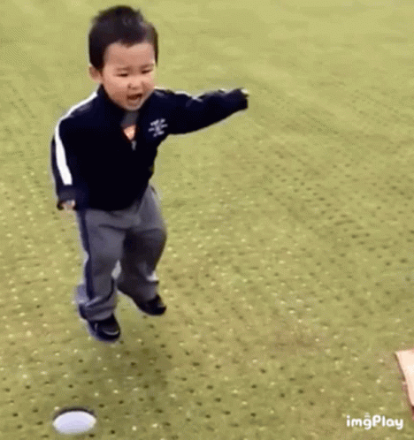 Young Boy Jumping and Playing With Ball