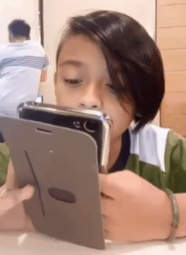 Young Boy Looking at Cell Phone