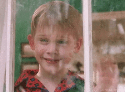 Young Boy Looking Out Window Smiling
