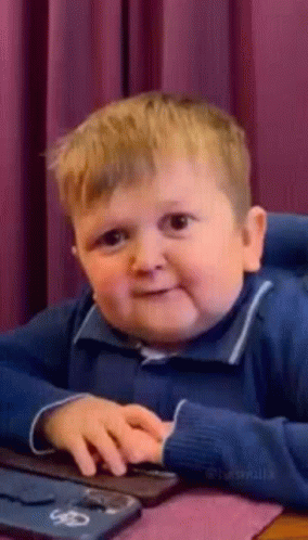 Young Boy Making Funny Face At Computer GIF