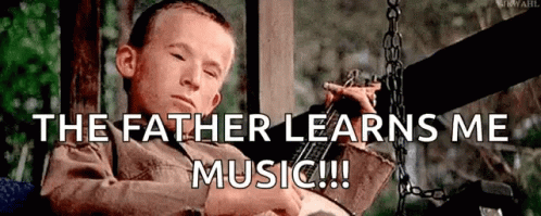 Young Boy on Swing With The Father Learns Me Music