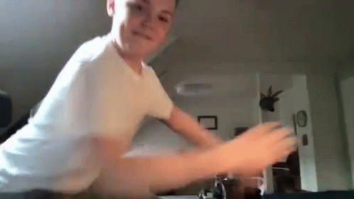 Young Boy Playing Video Game in White Shirt