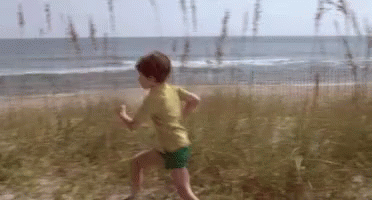 Young Boy Running on Sandy Beach