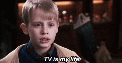 Young Boy Saying TV Is My Life in Front of Christmas Stocking