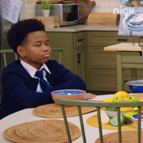 Young Boy Sitting At Table With Bowl Of Food And Nickelodeon Logo GIF