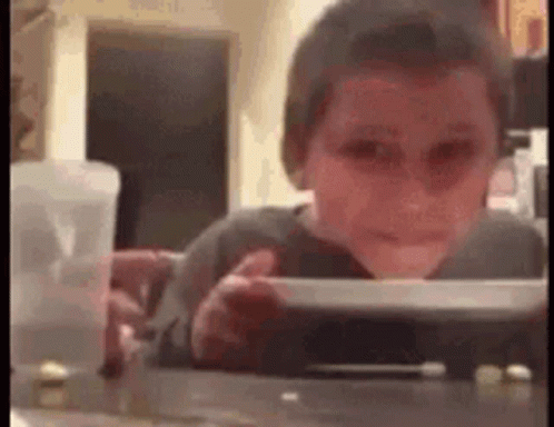 Young Boy Sitting at Table with Food