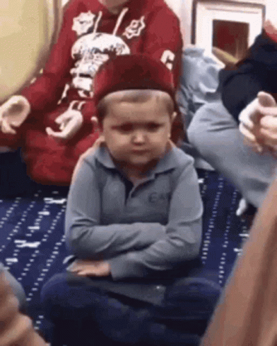 Young Boy Sitting Crossed Arms Wearing Hat GIF