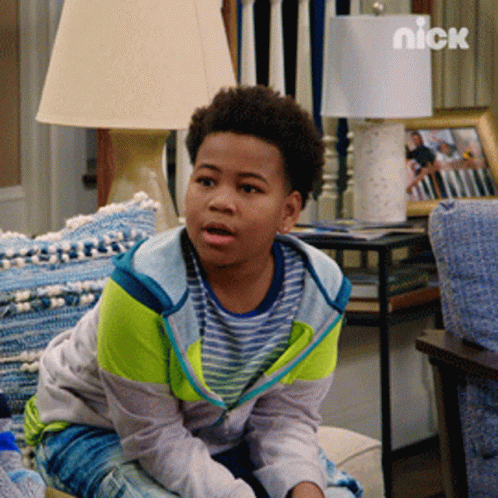Young Boy Sitting on Couch With Nick Logo