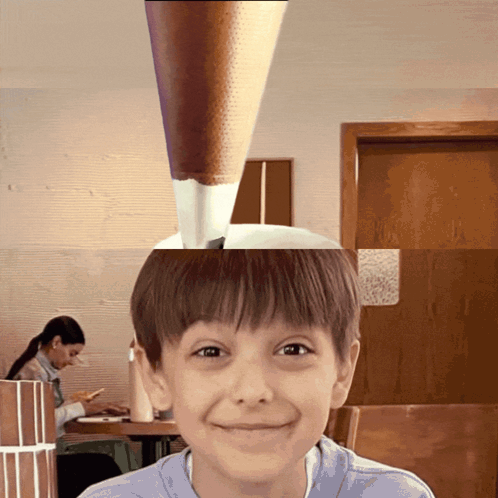 Young Boy Smiling In Front Of Woman At Table GIF
