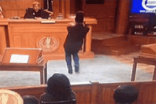 Young Boy Standing Before Judge in Courtroom