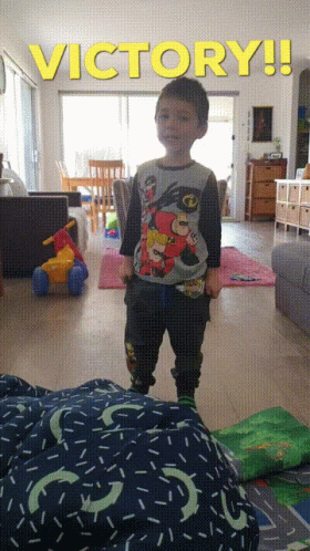 Young Boy Standing Under Victory Sign