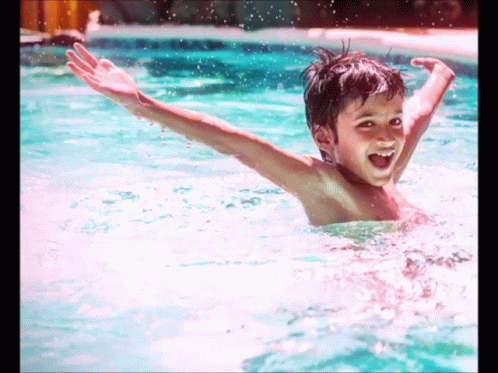 Young Boy Swimming Smiling