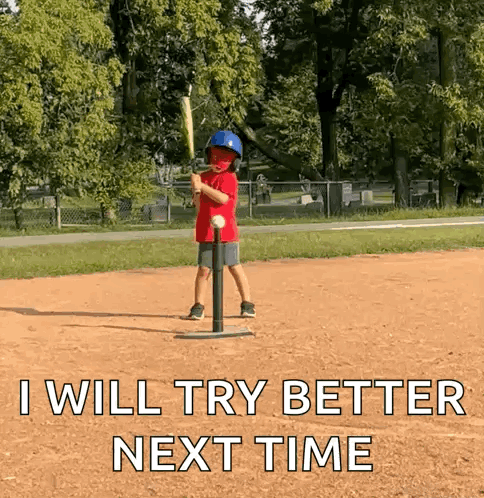 Young Boy Swinging Bat at Baseball on Tee