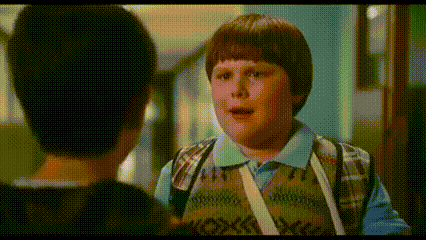 Young Boy Talking to Another Boy in Hallway
