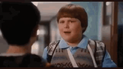 Young Boy Talking to Another Boy in Hallway