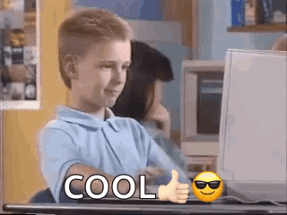 Young Boy Thumbs Up at Computer