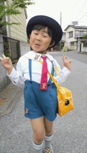 Young Boy White Shirt Blue Shorts Red Tie Yellow Bag GIF