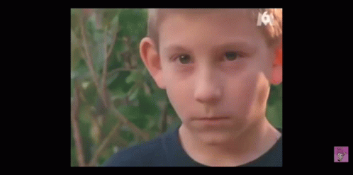 Young Boy With Bandage on Head Looking at Camera