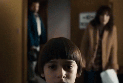 Young Boy With Bob Hairstyle in Front of Woman and Man