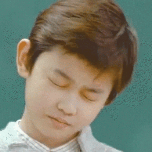 Young Boy With Eyes Closed Looking Down GIF