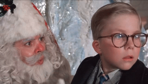Young Boy With Glasses Next to Santa Claus