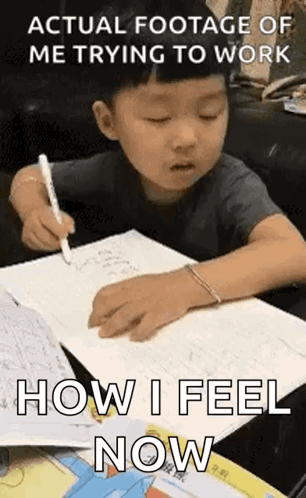 Young Boy Writing in Notebook at Table