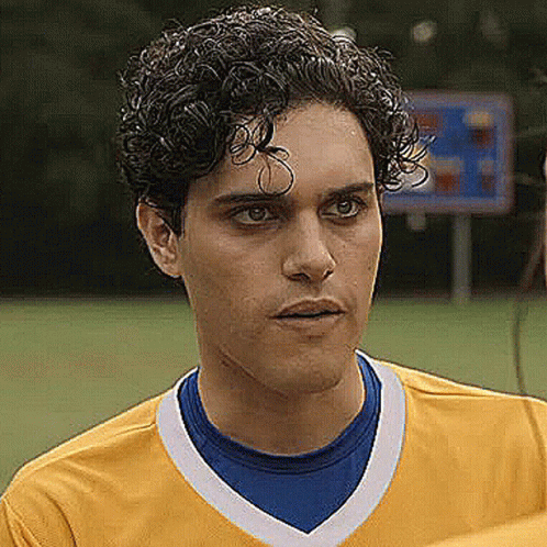 Young Curly Haired Man in Yellow Blue Soccer Jersey