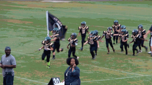 Young Football Players in Black and Gold Uniforms Number 27