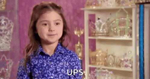 Young Girl in Blue Shirt Standing by Trophies