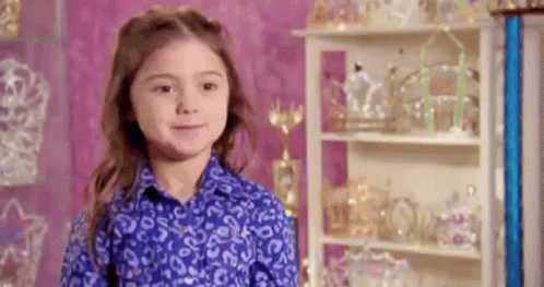 Young Girl in Blue Shirt with Trophies