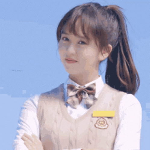 Young Girl in School Uniform With Arms Crossed and Ponytail