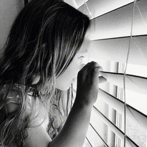 Young Girl Looking Out The Window GIF
