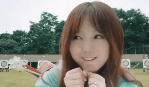 Young Girl Smiling Holding Bow and Arrow