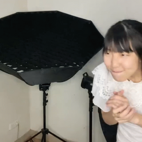 Young Girl Standing in Front of Black Umbrella