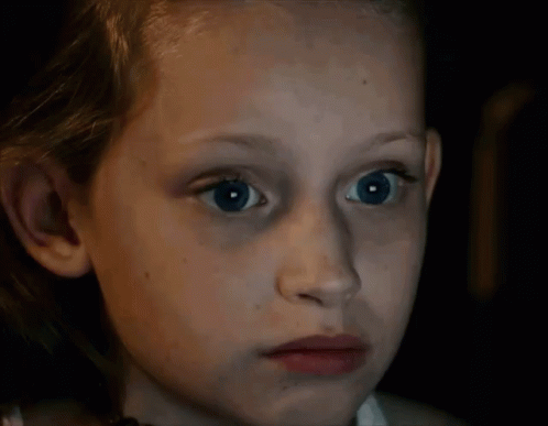 Young Girl with Blue Eyes Looking at Camera