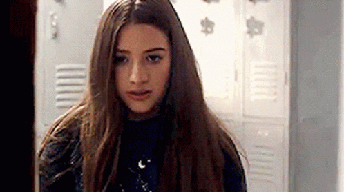 Young Girl With Long Hair in Front of Locker