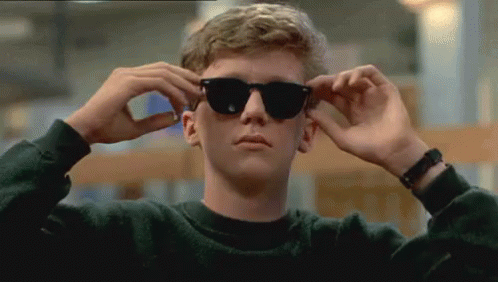 Young Man Adjusting Sunglasses