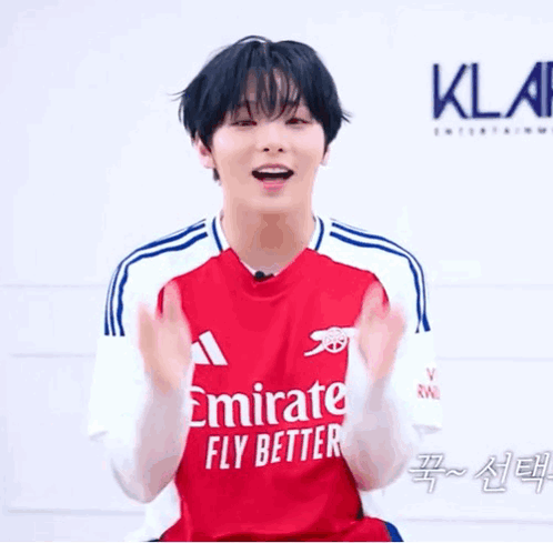 Young Man Clapping In Red Emirates Jersey GIF