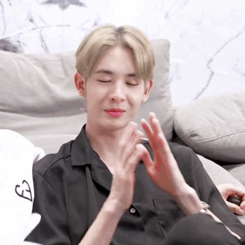 Young Man Clapping With Eyes Closed