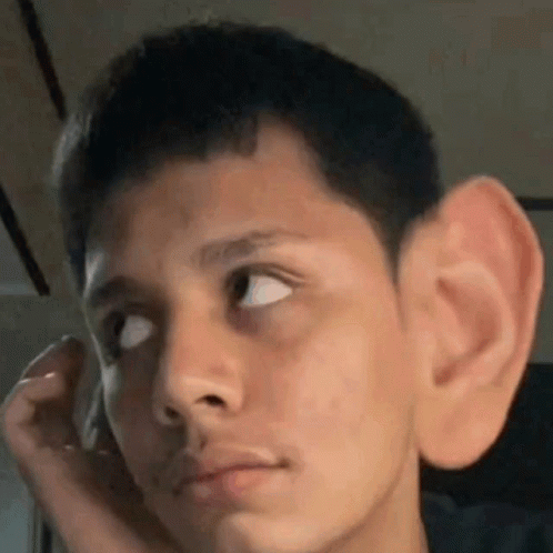 Young Man Covering Ear and Looking Up