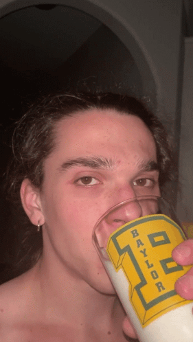Young Man Drinking From Baylor Glass