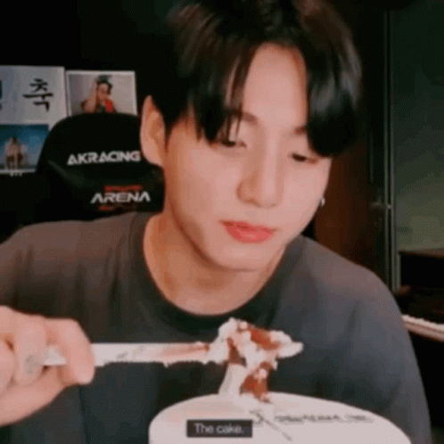 Young Man Eating Cake With Fork and Spoon