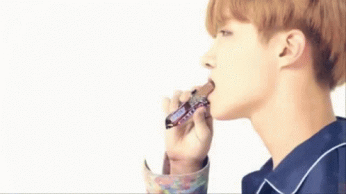 Young Man Eating Snickers Bar