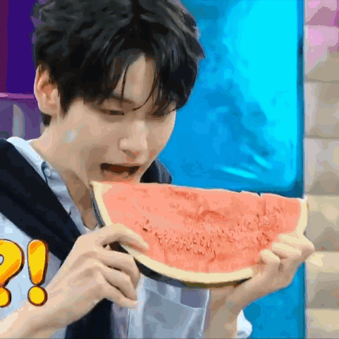 Young Man Eating Watermelon with Exclamation Point