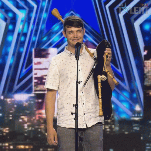 Young Man Holding Bagpipe at Espana Talent Sign